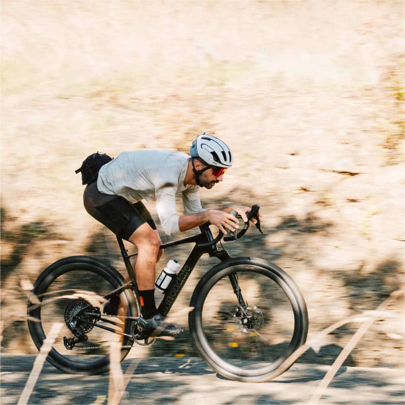 Collection of four insulated travel bottles on wooden shelf.
